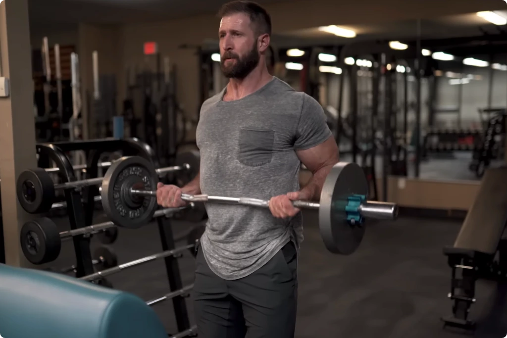 A man doing EZ Bar Drag Curl